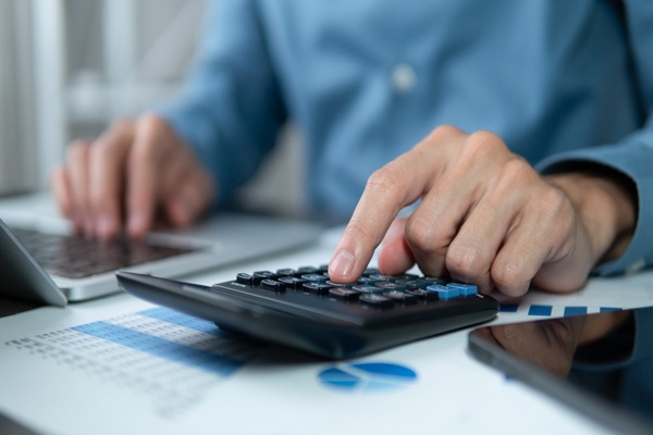 Businessman,Hands,Using,A,Calculator,To,Check,Company,Finances,And