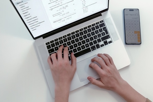 High,Angle,View,Of,Student,Hands,Typing,On,Laptop,Computer